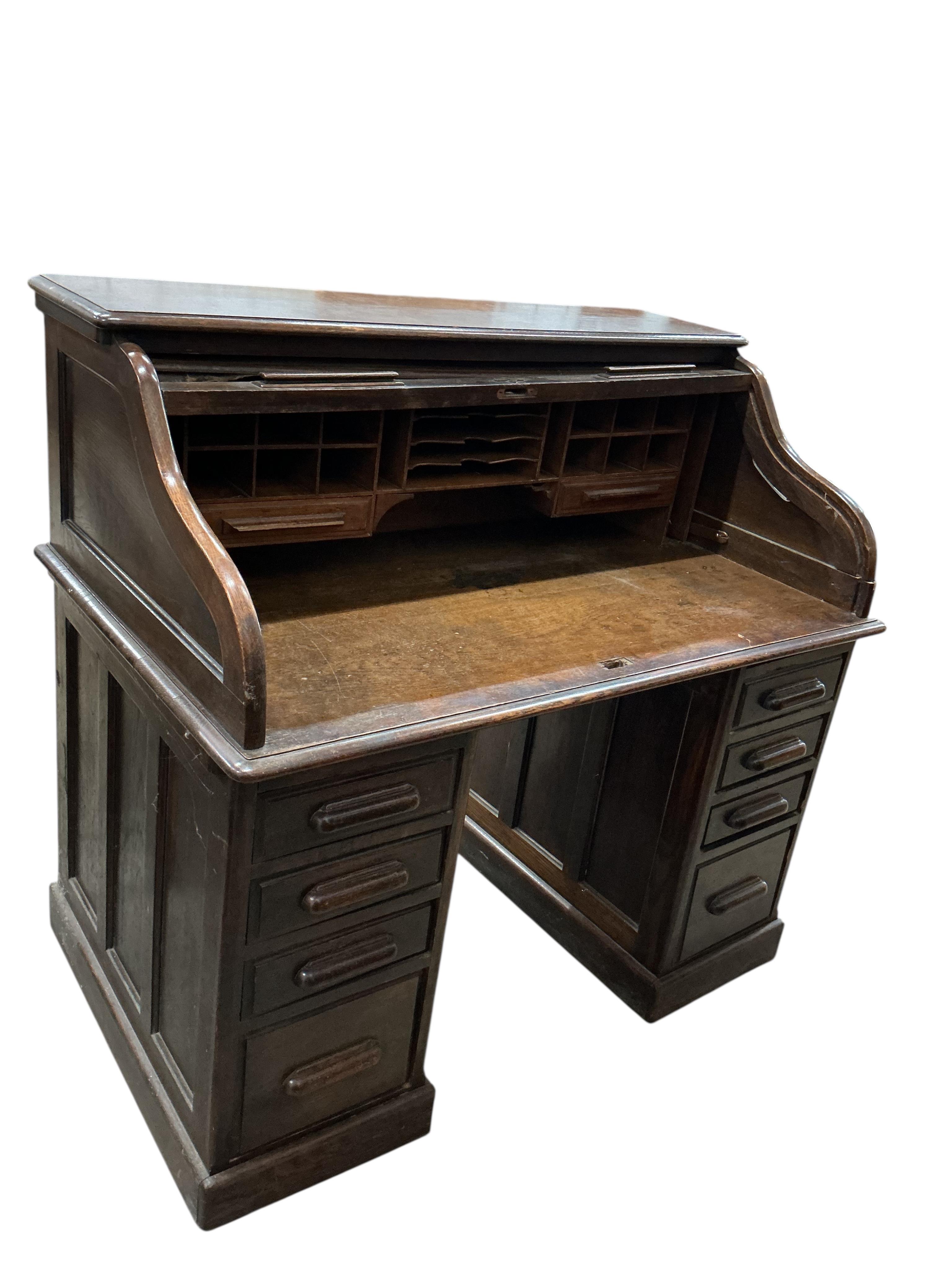 An early 20th century oak 'S' shaped tambour roll top desk, width 124cm, depth 78cm, height 120cm